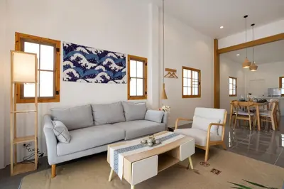 a living room with a couch and a table at Villa Sunrise Garden B190 in Thalang