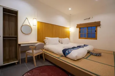 a bedroom with a large bed and a mirror at Villa Sunrise Garden B190 in Thalang