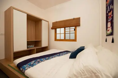 a bedroom with a large white bed with a window at Villa Sunrise Garden B190 in Thalang