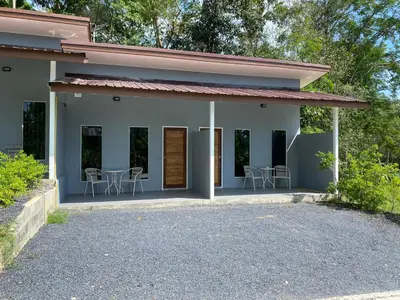 a white house with chairs and tables in it at Kohyao Non Bay in Ko Yao Yai