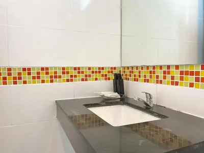 a bathroom with a sink and a mirror at Patong Platinum in Patong Beach