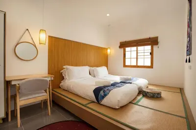 a bedroom with a large bed and a desk at Villa Sunrise Garden B191 in Thalang