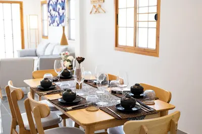 a wooden table with chairs and a dining room at Villa Sunrise Garden B191 in Thalang