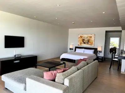 a living room with a bed and a couch and a bed at Spectacular Ocean View Apartment in Ban Saiyuan (1)