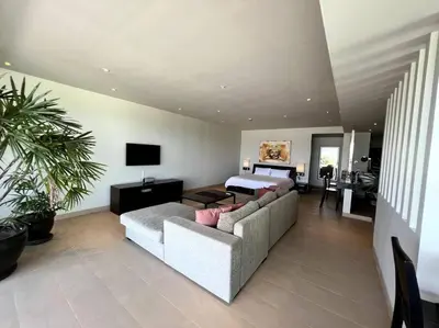 a living room with a couch and a bed at Spectacular Ocean View Apartment in Ban Saiyuan (1)