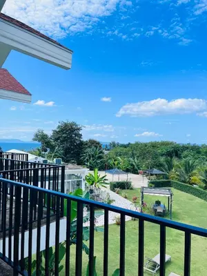 a balcony with a view of a park at White Seaview Residence in Klong Muang Beach