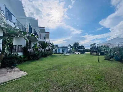 a large yard in front of a building at White Seaview Residence in Klong Muang Beach