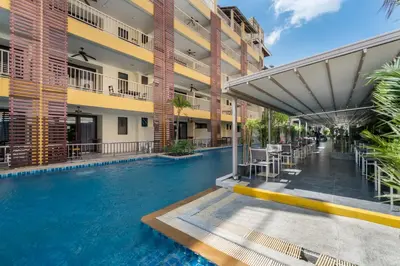 a swimming pool in the middle of a building at Tuana Hotels Casa Del Sol in Kata Beach