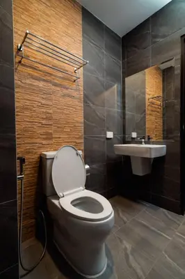 a bathroom with a toilet and a sink at Terminal 58 Airport in Ban Mut Dok Khao