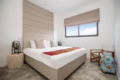 a bedroom with a large bed with a window at New & Elegant 5Br Pool Villa Samakki Garden 5 in Rawai Beach