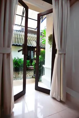 an open door with a mirror in a room at Palm Resort Krabi in Ban Ko Kwang