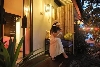 a woman in a white dress and a hat at Palm Resort Krabi in Ban Ko Kwang