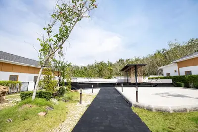 a walkway leading to a building with a bridge at Villa Sunrise Garden A181 in Thalang