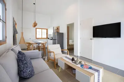a living room with a couch and a table at Villa Sunrise Garden A181 in Thalang
