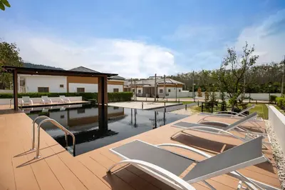 a patio with chairs and a swimming pool at Villa Sunrise Garden A181 in Thalang