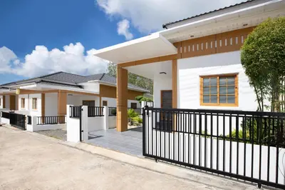 a house with a black fence in front of it at Villa Sunrise Garden A181 in Thalang