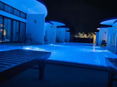 a large swimming pool at night with blue lighting at Blue Ba You Resort in Ban Khlong Haeng