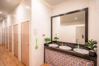 a bathroom with two sinks and a large mirror at The Dorm Hostel in Ban Lo Long