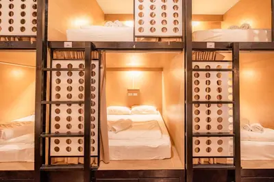 a group of bunk beds in a room at The Dorm Hostel in Ban Lo Long