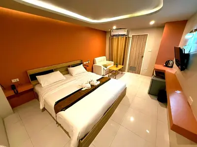 a bedroom with a large bed and a television at THE NICE in Patong Beach