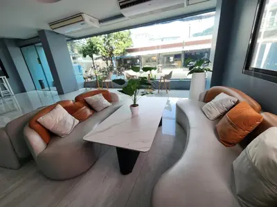 a living room with two couches and a table at THE NICE in Patong Beach