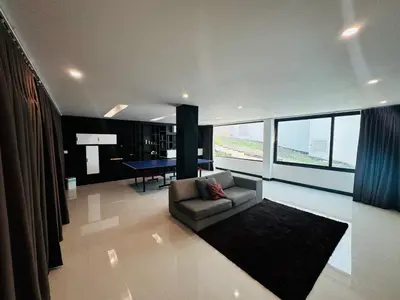 a living room with a couch and a table at Sunrise Ocean Villa 20 in Phuket Town