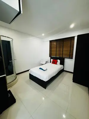 a bedroom with a bed and a window in it at Sunrise Ocean Villa 20 in Phuket Town