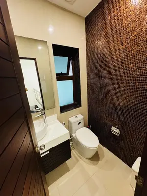 a bathroom with a toilet and a sink and a mirror at Sunrise Ocean Villa 20 in Phuket Town