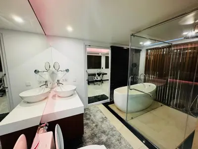 a bathroom with two sinks and a tub and a shower at The Sunrise Ocean Villa 22 in Phuket Town