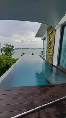 a swimming pool in a house with a view of the water at The Sunrise Ocean Villa 22 in Phuket Town