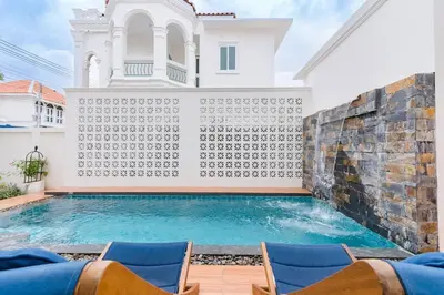 a villa with a swimming pool and chairs at Phuket's unique Sino-style villa with private pool in Ban Bang Khu