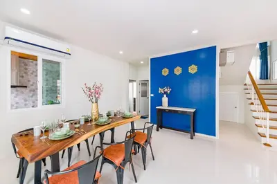 a dining room with a wooden table and chairs at Phuket's unique Sino-style villa with private pool in Ban Bang Khu