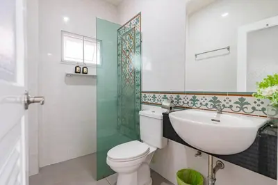 a bathroom with a toilet and a sink and a shower at Phuket's unique Sino-style villa with private pool in Ban Bang Khu