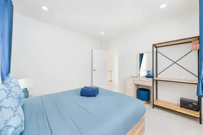 a bedroom with a blue bed and a shelf at Phuket's unique Sino-style villa with private pool in Ban Bang Khu
