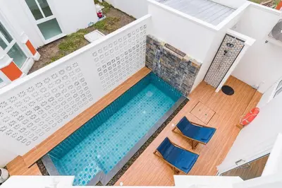 an overhead view of a swimming pool with two chairs at Phuket's unique Sino-style villa with private pool in Ban Bang Khu