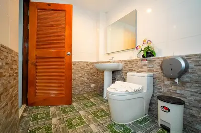 a bathroom with a toilet and a sink at ฺBaan Waru seaview villa in Kata Beach