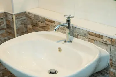 a white sink with a faucet in a bathroom at ฺBaan Waru seaview villa in Kata Beach