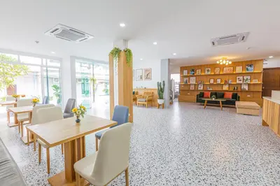 a waiting room with tables and chairs in a building at South Siam Hotel in Phuket Town