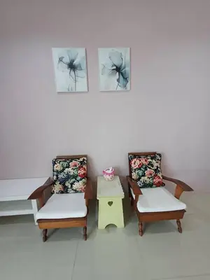 two chairs and a table in a room at 168Hostel Airport@Phuket in Thalang