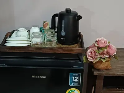 a tray on top of a stove with a coffee maker at 168Hostel Airport@Phuket in Thalang