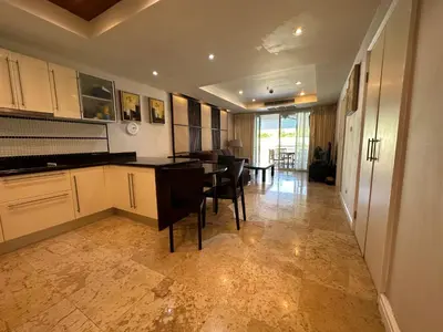 a kitchen with white cabinets and a table and chairs at Bel Air Cape Panwa resort apartment in south Phuket with pool access ,near Ao Yon in Phuket Town