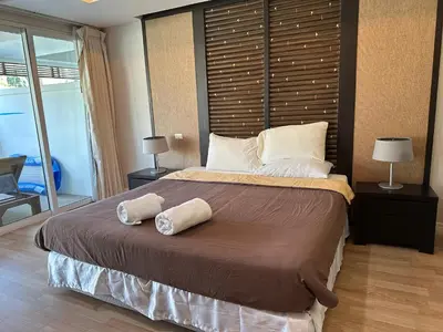 a bedroom with a large bed with two towels on it at Bel Air Cape Panwa resort apartment in south Phuket with pool access ,near Ao Yon in Phuket Town