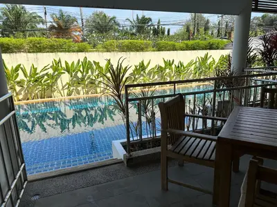a view of a swimming pool from a balcony at Bel Air Cape Panwa resort apartment in south Phuket with pool access ,near Ao Yon in Phuket Town
