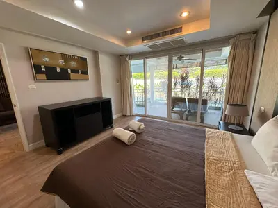 a bedroom with a large bed and a television at Bel Air Cape Panwa resort apartment in south Phuket with pool access ,near Ao Yon in Phuket Town