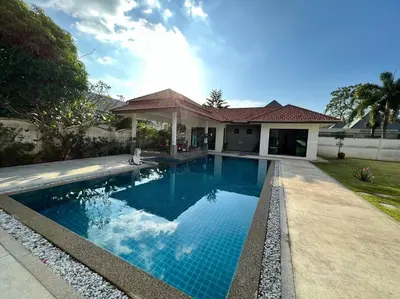 a swimming pool in front of a house at Maya Villa by G Estate in Rawai Beach
