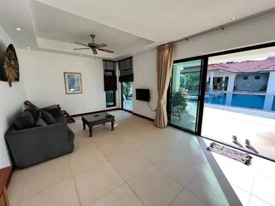 a living room with a couch and a table at Maya Villa by G Estate in Rawai Beach