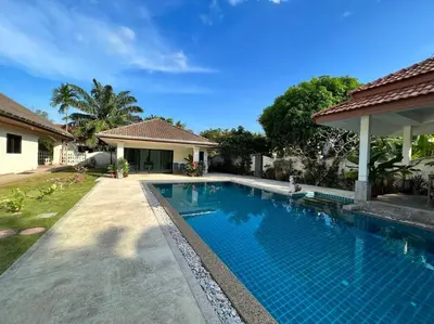 a swimming pool in front of a house at Maya Villa by G Estate in Rawai Beach