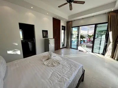 a bedroom with a white bed and a large window at Maya Villa by G Estate in Rawai Beach