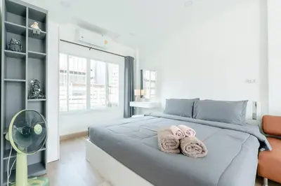 two towels on a bed in a bedroom at White House Apartment - Chalong in Chalong
