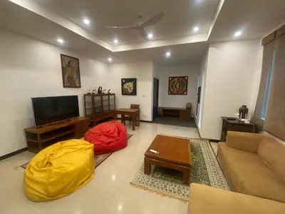 a living room with a couch and a yellow cover at Seaview Prima Villa Karon beach in Karon Beach